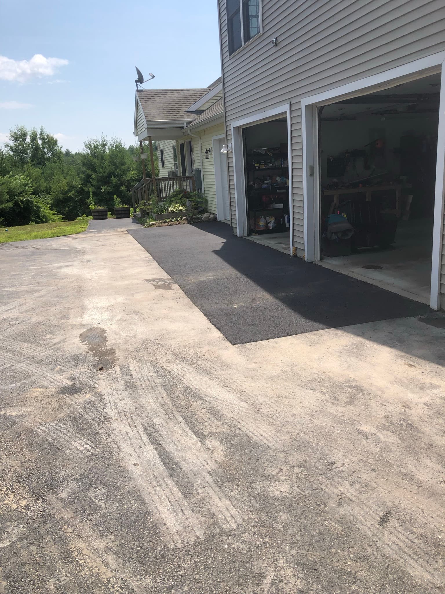 Completed square-cut asphalt patch in winter conditions, solid repair even in cold weather